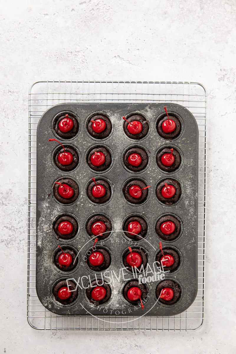 Baking tray with red cherries on a textured white surface