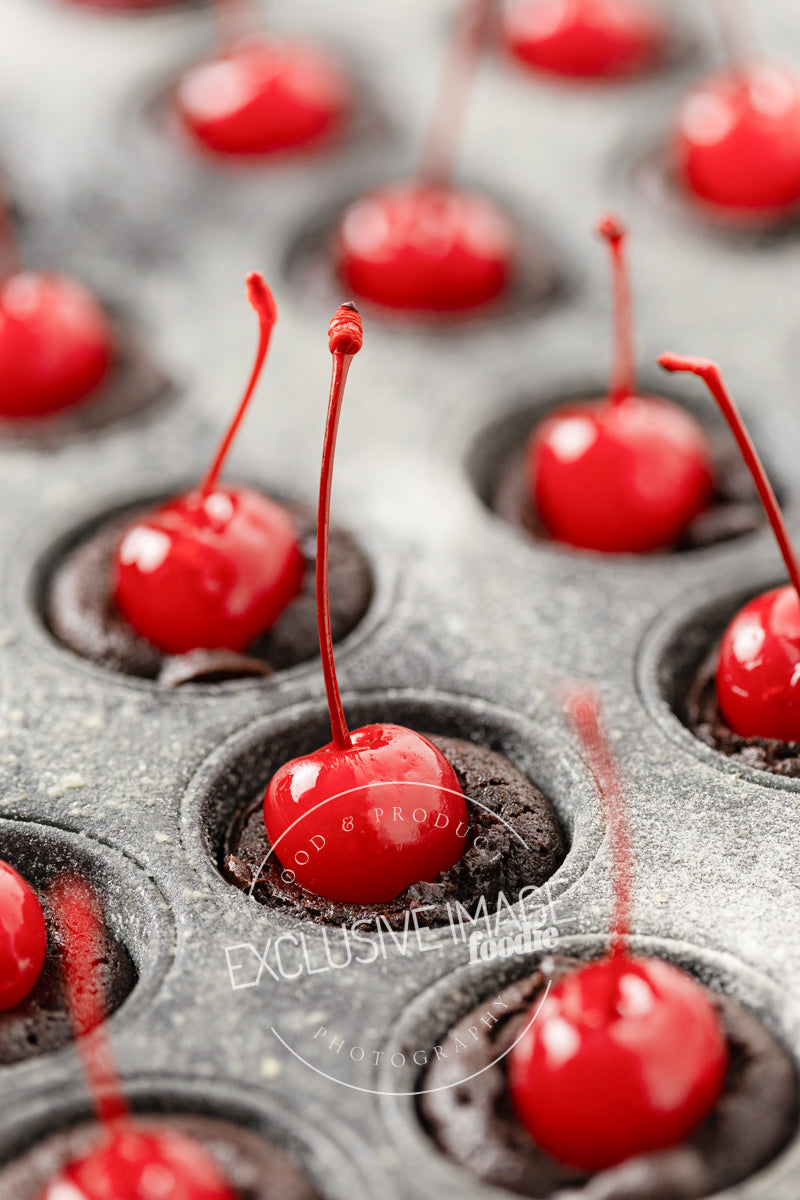 Close-up of red maraschino cherries in a muffin tin