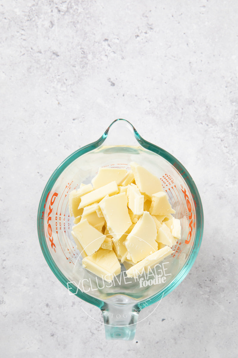 White chocolate in a glass container for melting