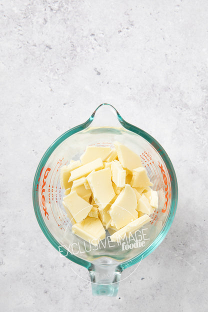 White chocolate in a glass container for melting