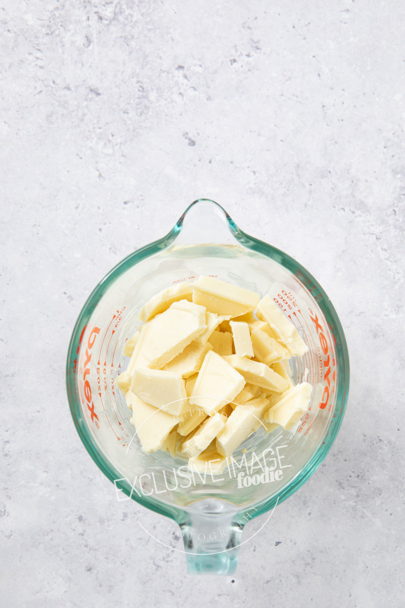 White chocolate in a glass container for melting
