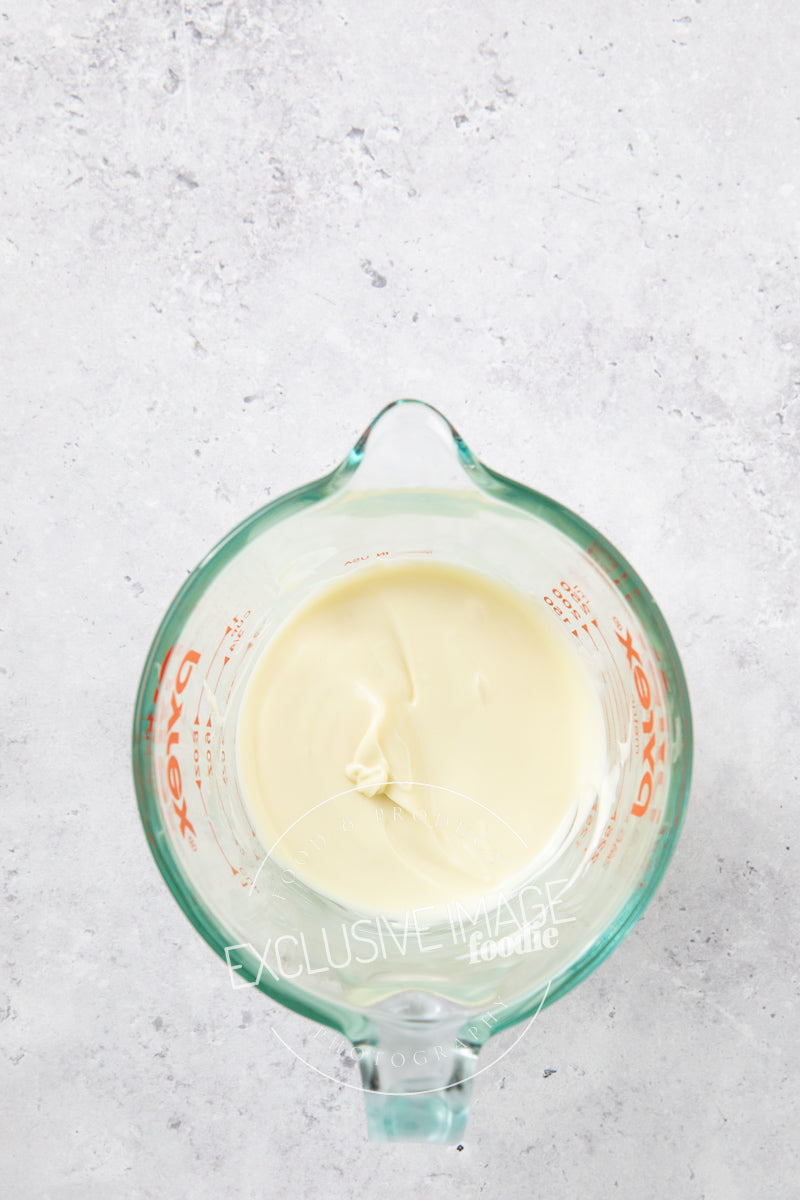 White chocolate in a glass container for melting