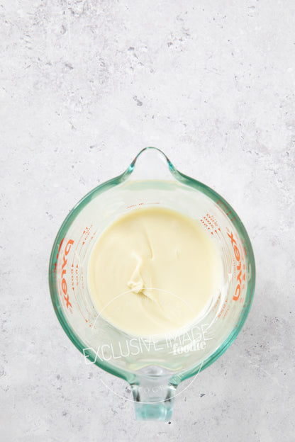 White chocolate in a glass container for melting