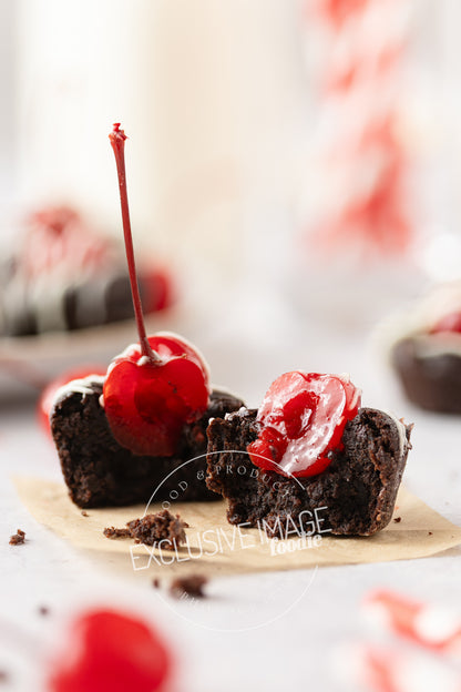 Chocolate mini brownie with cherries on parchment square with a blurred background